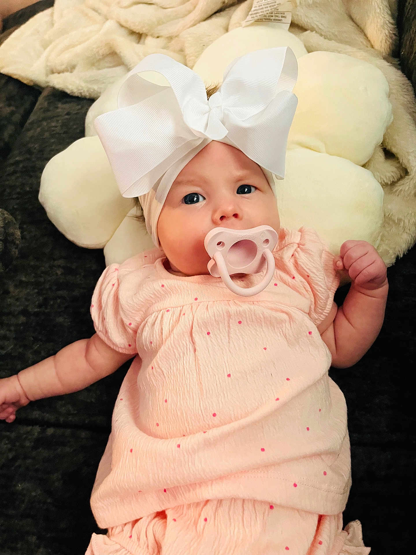 Adalynn Rose is registered to the contest to win money with this photo: baby, infant, pacifier, headband, bow, pink_dress, cute, lying_down, pillow, soft_texture, indoor, child, adorable, portrait, clothing, person, young_child, expression, baby_girl, comfortable