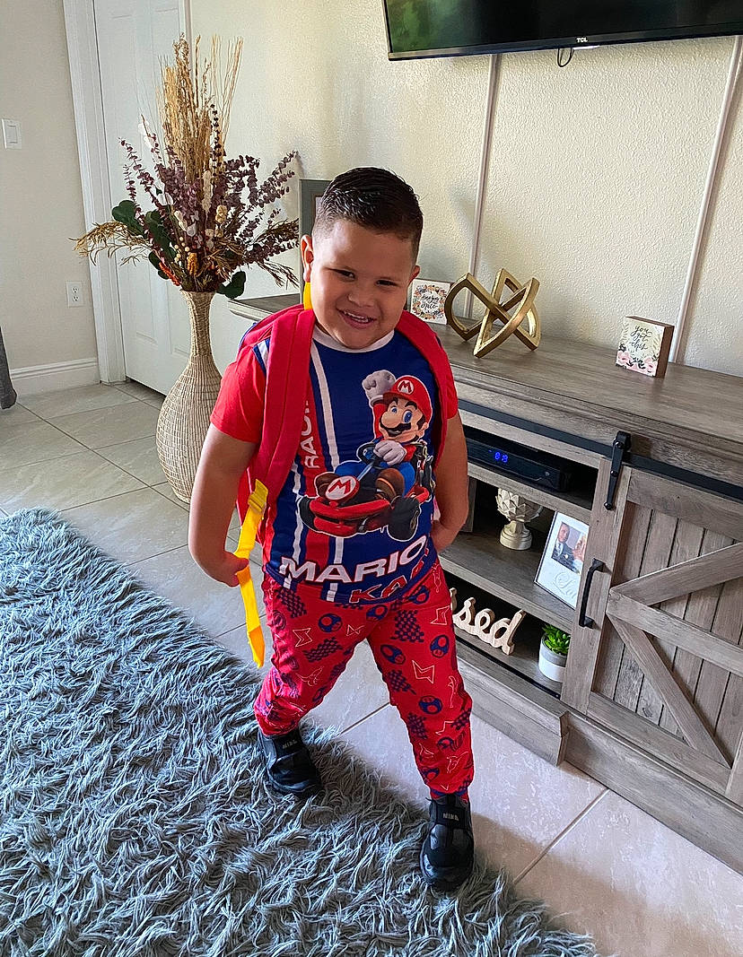Jadiel joined the competition — help win amazing prizes! carmine, child, electric_blue, fictional_character, floor, flooring, flowerpot, fun, happy, home, houseplant, joy, person, plant, room, shoe, sleeve, smile, sportswear, t_shirt