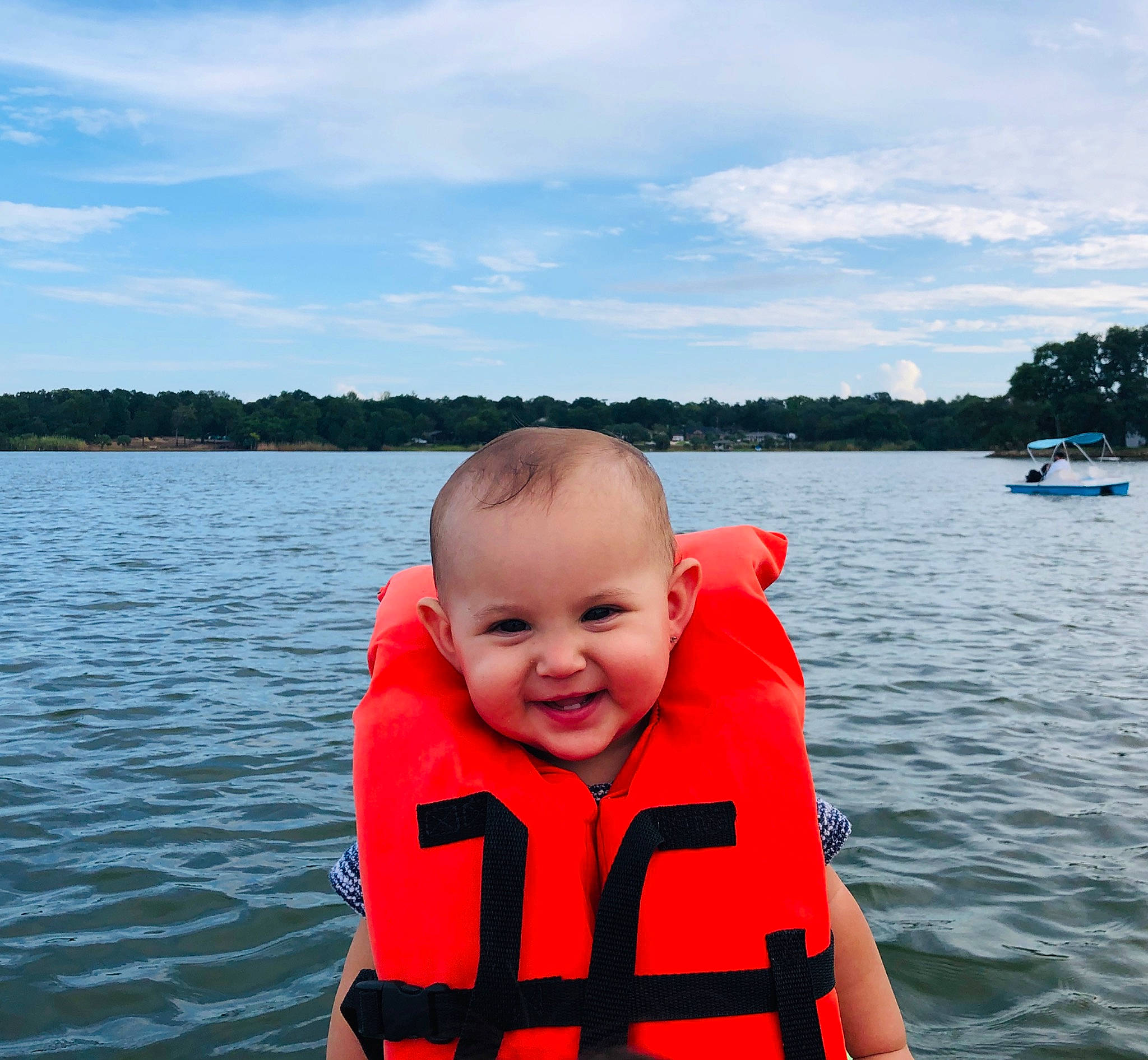 Haya is registered to the contest to win money with this photo: boat, boating, child, fun, joy, lake, lake_district, leisure, lifejacket, person, personal_protective_equipment, recreation, red, summer, toddler, vacation, vehicle, water, watercraft
