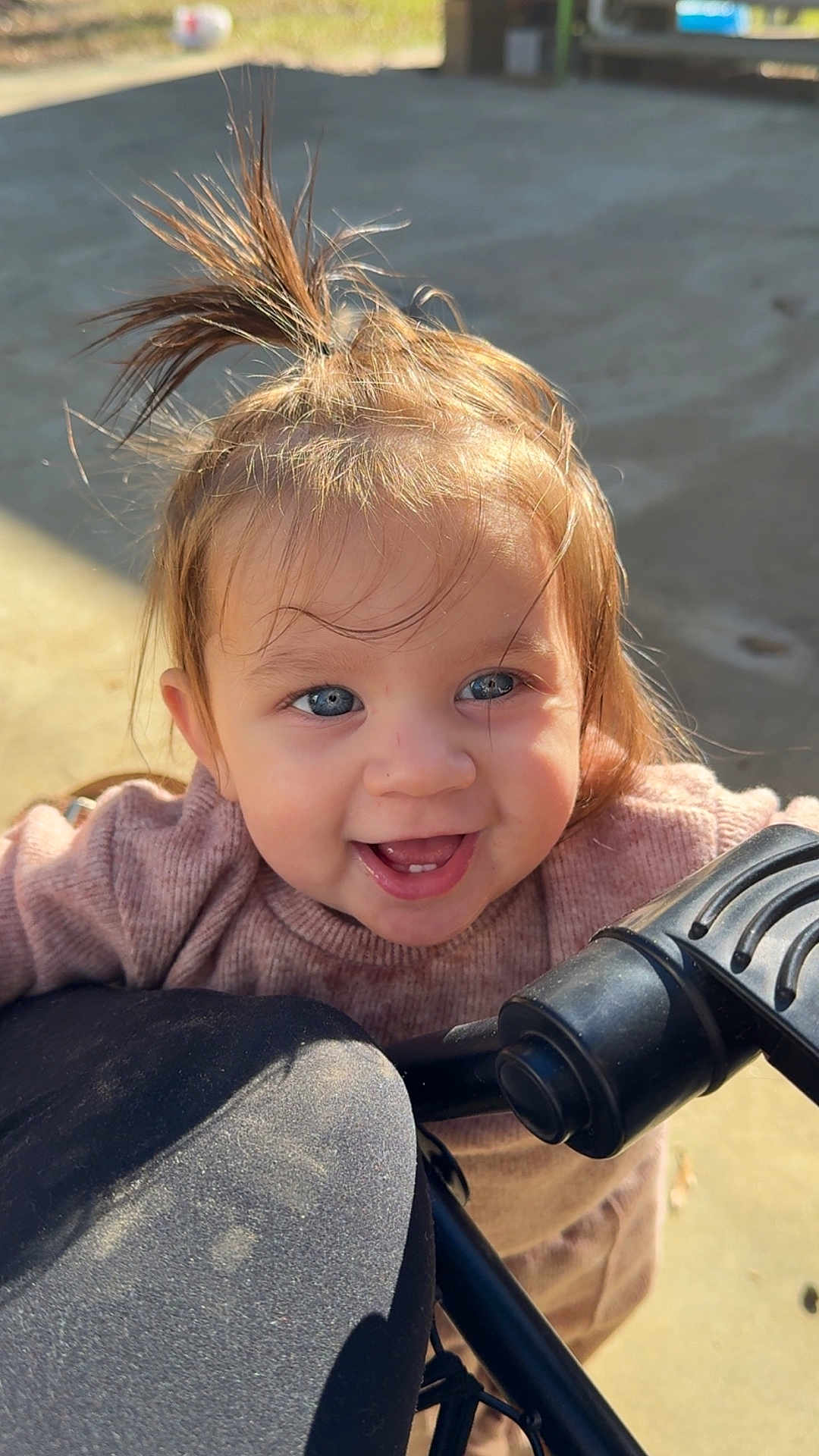 Selah joined the competition — help win amazing prizes! toddler, child, smiling, blue_eyes, hair_tuft, stroller, outdoor, sunlight, happy, face, person, sweater, cute, baby, portrait, young_child, daylight, expression, playful, casual
