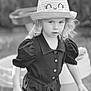 Romy a rejoint le concours — aidez-le/la à gagner de superbes lots ! child, hat, outdoor, portrait, black_and_white, young, curly_hair, clothing, person, face, expression, nature, casual, daylight, cute, fashion, summer, playful, closeup, innocence