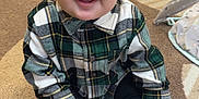 Giovanni joined the competition — help win amazing prizes! baby, child, smiling, plaid_shirt, socks, carpet, indoor, toy, baby_seat, floor, hand, person, crawling, cute, happy, home, infant, toddler, room, clothing