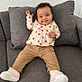 baby, bodypart, clothing, couch, cushion, face, finger, footwear, furniture, hand, happy, head, homedecor, pants, person, photography, pillow, portrait, shoe, sitting