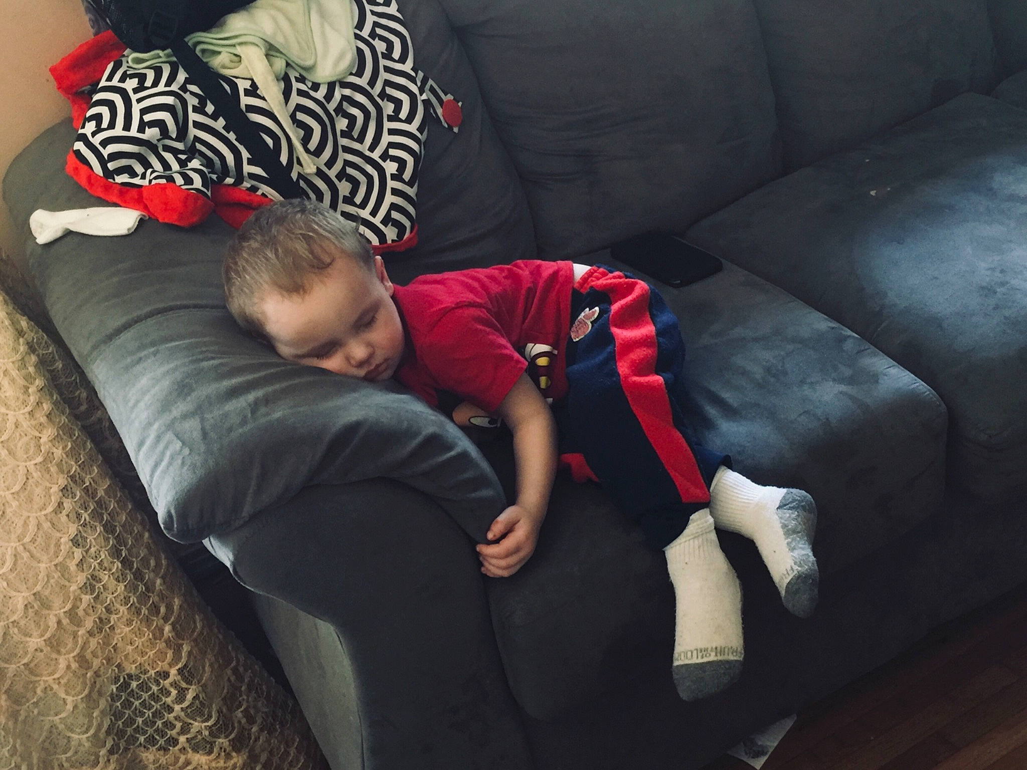 Brantley is registered to the contest to win money with this photo: child, comfort, couch, furniture, hand, human, jeans, lap, leg, love, mountain, nap, person, play, shoe, sitting, sleep, sportswear, t_shirt, toddler