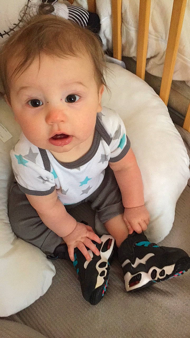 Levi is registered to the contest to win money with this photo: baby, baby_products, baby_toddler_clothing, cheek, child, cool, eye, finger, footwear, head, leg, lip, mouth, person, play, product, shoe, skin, smile, surprise