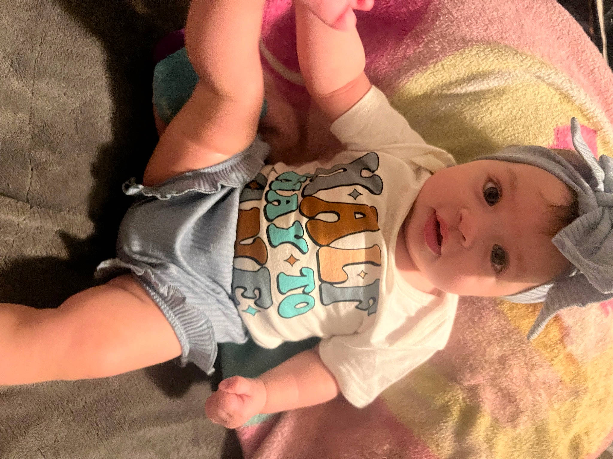 Amirah is registered to the contest to win money with this photo: arm, baby, baby_toddler_clothing, cheek, comfort, eyelash, facial_expression, finger, gesture, hand, headwear, human_body, joint, leg, mouth, neck, nose, person, pink, skin