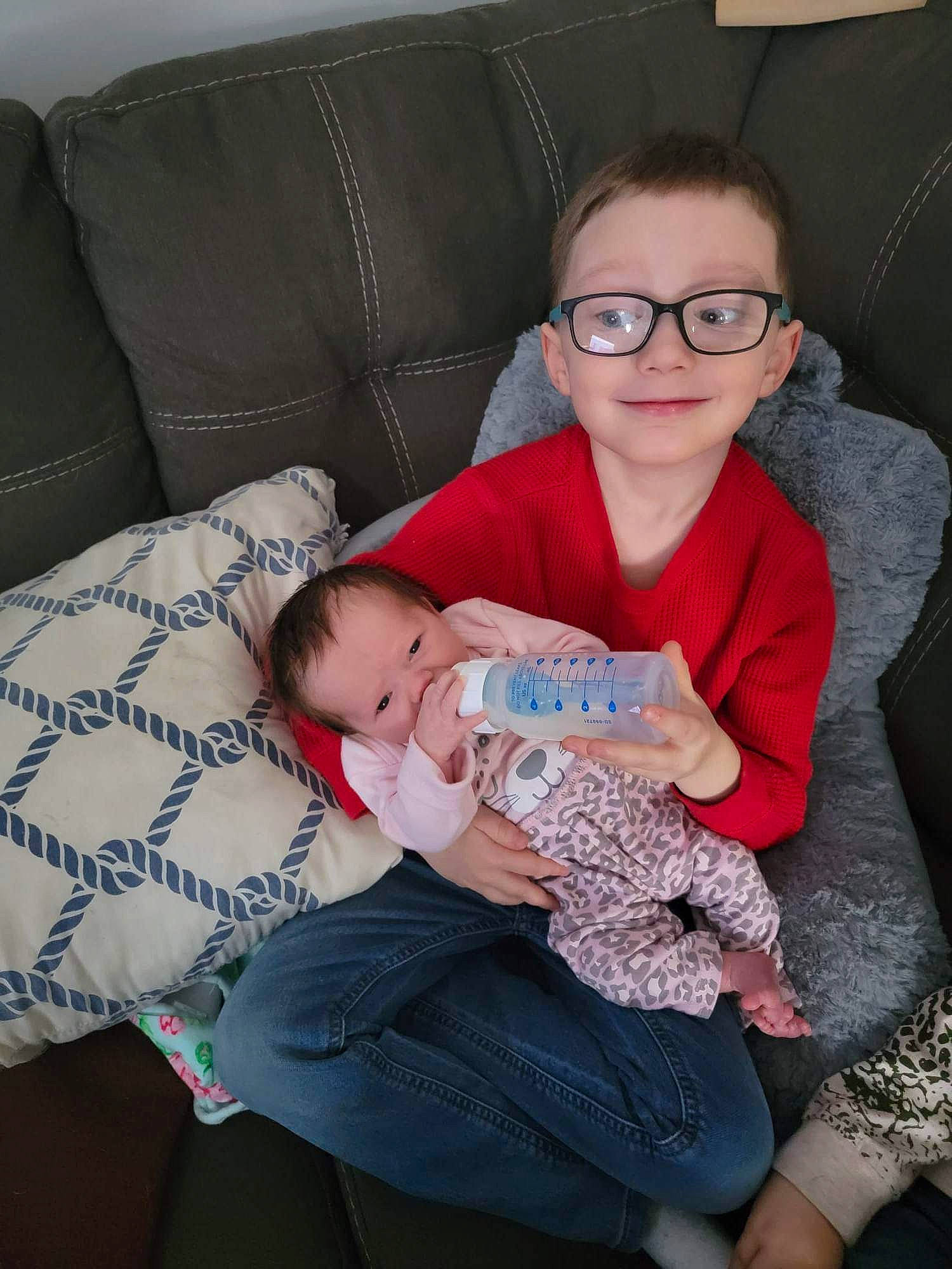 Chanler Rylan is registered to the contest to win money with this photo: baby, baby_toddler_clothing, comfort, couch, eye, fun, glasses, happy, human_body, iris, joy, lap, leg, mouth, person, skin, smile, textile, thigh, toddler