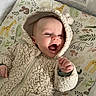 Corvus joined the competition — help win amazing prizes! baby, child, infant, hood, jacket, clothing, smiling, happy, crib, mattress, pattern, animal_print, giraffe, elephant, cat, leaf, greenery, indoor, cute, portrait