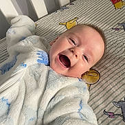 Corvus joined the competition — help win amazing prizes! baby, smiling, face, onesie, bed, crib, winnie_the_pooh, sheet, child, happy, infant, lying_down, cute, indoor, person, plush, soft, clothing, portrait, expression