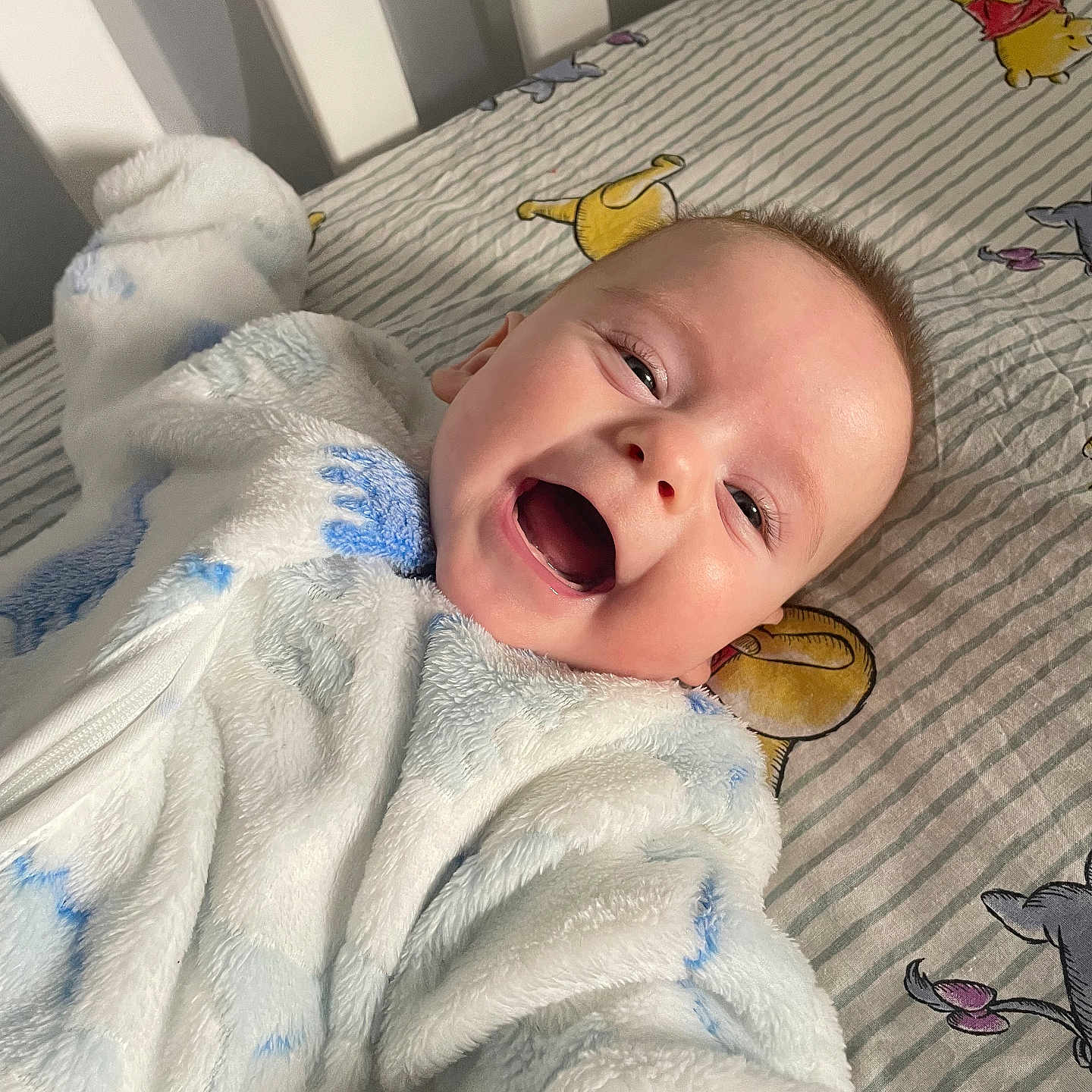 Corvus joined the competition — help win amazing prizes! baby, smiling, face, onesie, bed, crib, winnie_the_pooh, sheet, child, happy, infant, lying_down, cute, indoor, person, plush, soft, clothing, portrait, expression
