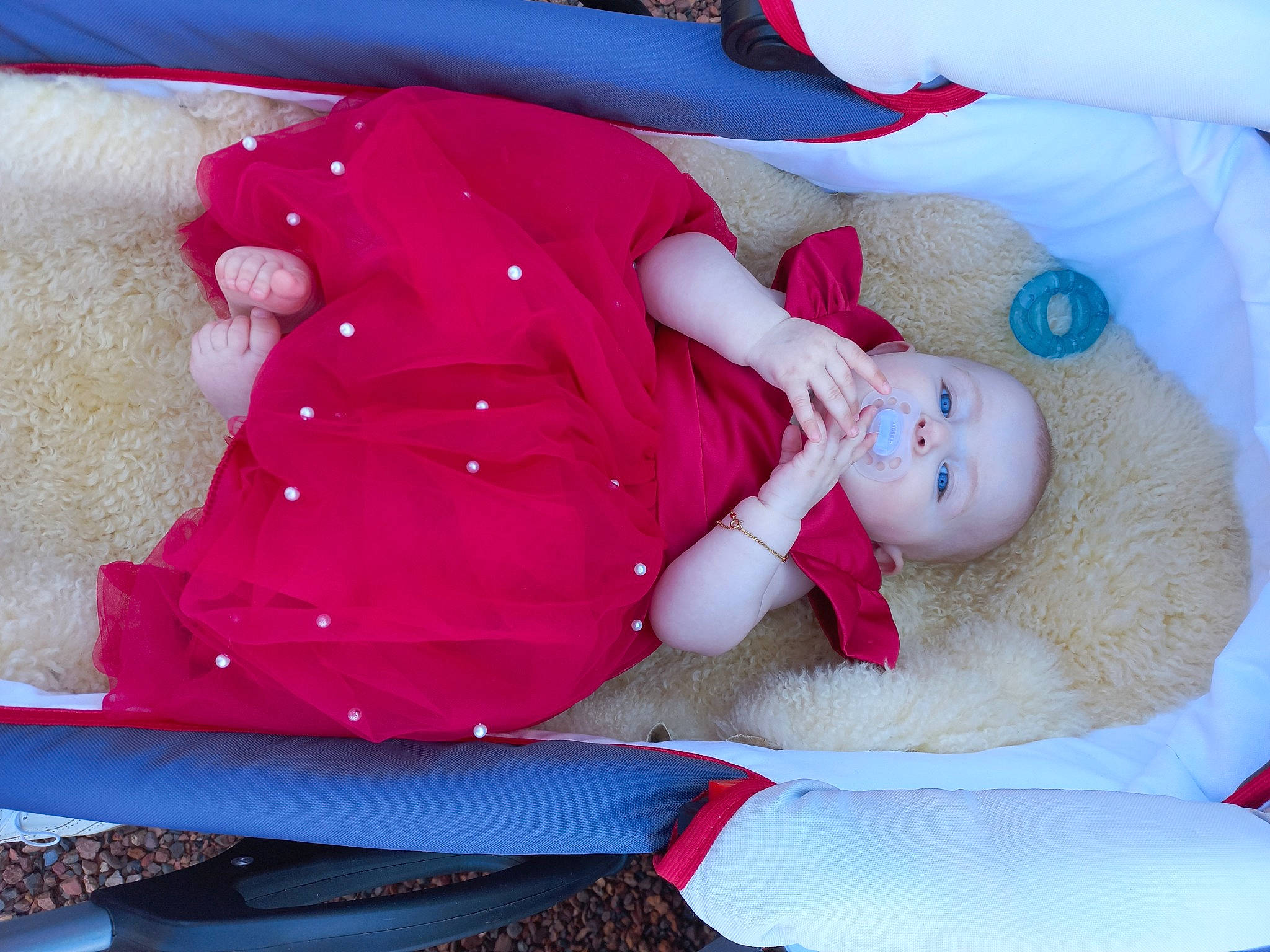 Lydia participe au concours pour gagner de l'argent avec cette photo : baby, baby_products, baby_sleeping, baby_toddler_clothing, blue, child, comfort, hat, headgear, headwear, human_body, lap, linens, magenta, person, pink, red, sleeve, sock, textile