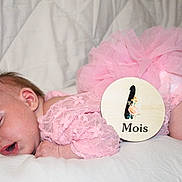 Amalya participe au concours pour gagner de l'argent avec cette photo : baby, celebration, child, clothing, cute, indoors, infant, lace, milestone, newborn, one_month, peaceful, pink, portrait, resting, sleeping, soft, tutu, white_background, wooden_sign