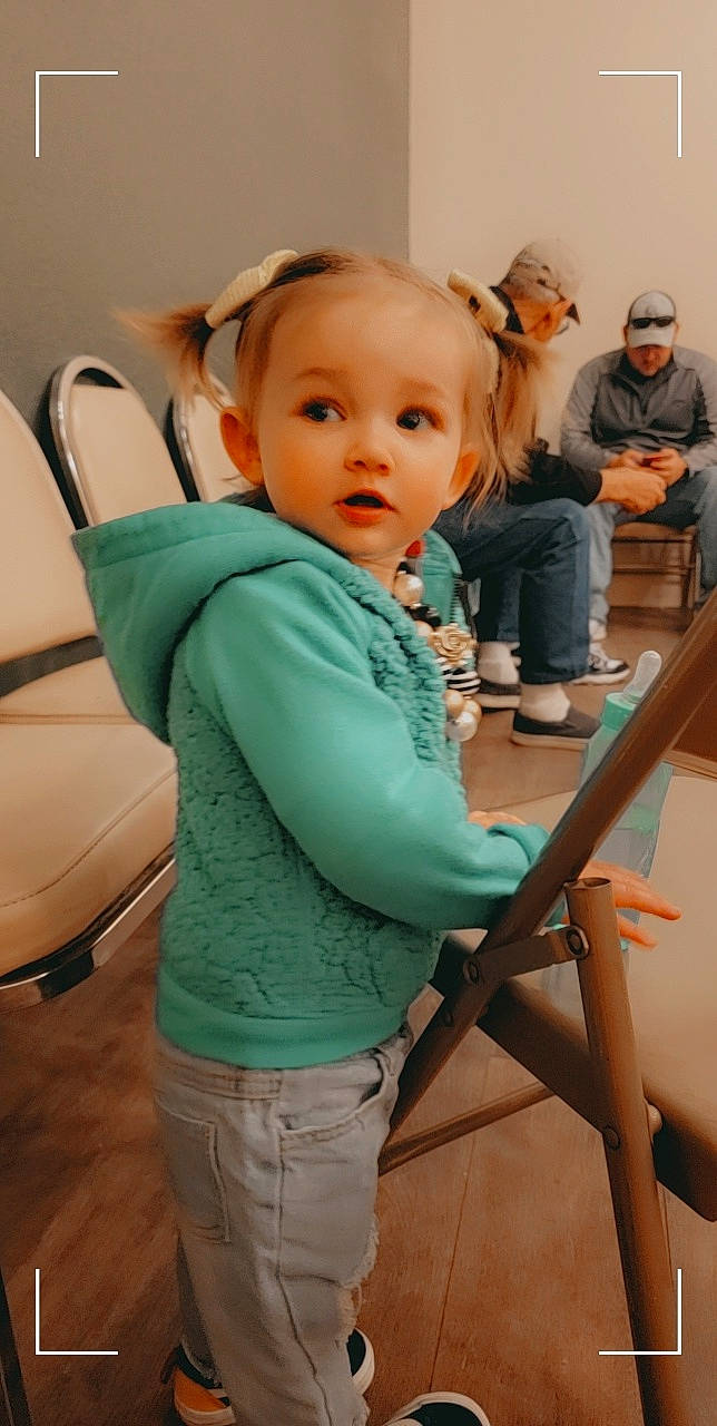 Angela is registered to the contest to win money with this photo: arm, baby, baby_toddler_clothing, chair, child, comfort, floor, flooring, fun, happy, hat, joint, leg, leisure, person, sitting, sleeve, t_shirt, toddler, trousers