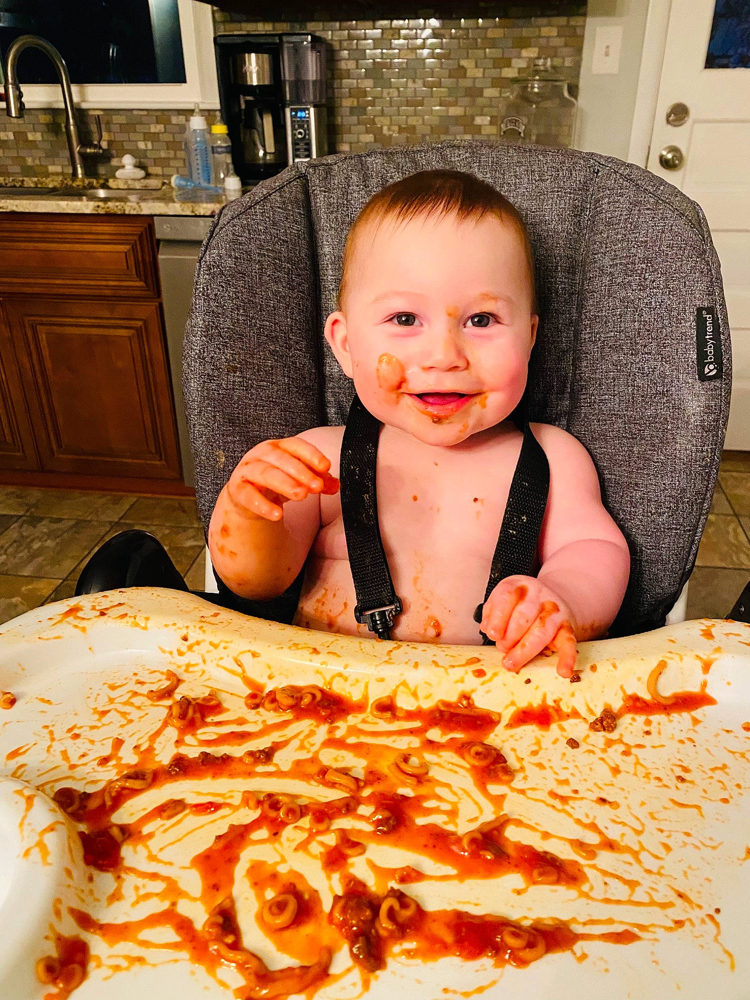 Israel is registered to the contest to win money with this photo: baby, cabinetry, child, countertop, cuisine, dish, eye, flooring, fun, happy, ingredient, joy, kitchen, kitchen_appliance, orange, peach, person, picture_frame, room, smile