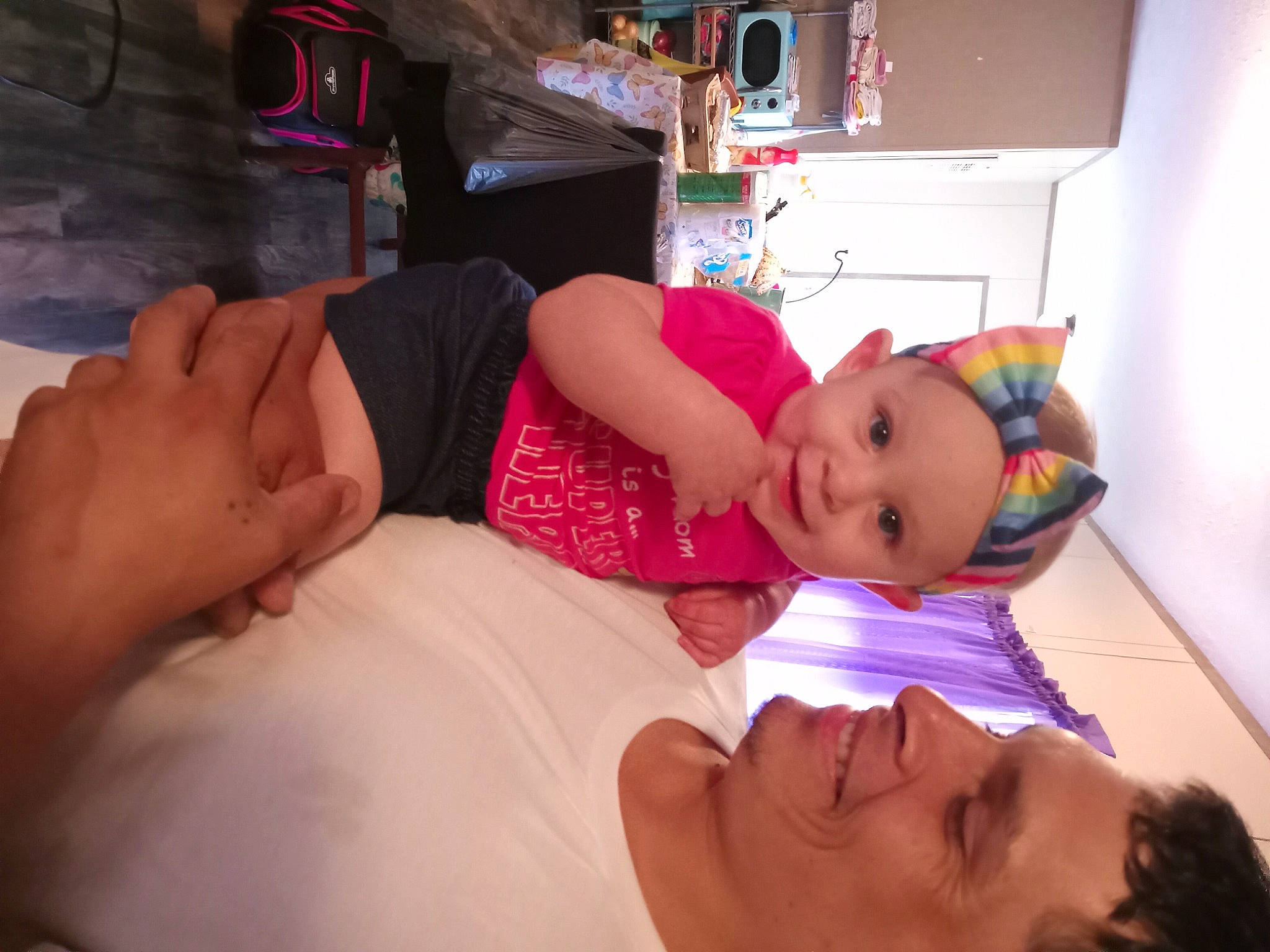 Luciana is registered to the contest to win money with this photo: abdomen, baby, child, comfort, dress, event, finger, fun, happy, hat, headwear, human_leg, joy, mouth, party, people, person, room, skin, smile