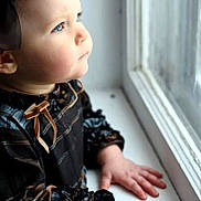 Kiriana is registered to the contest to win money with this photo: toddler, child, window, portrait, side_profile, bow, dress, hands, natural_light, indoor, curiosity, face, young_child, skin, blue_eyes, long_sleeves, person, looking_out, soft_light, expression
