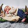 baby, newborn, infant, sleeping, knit_hat, knit_sweater, denim_jeans, wooden_bed, beige_blanket, green_pillow, faux_fur_rug, tiny_feet, tiny_hands, cozy, studio_photography, props, peaceful, portrait, newborn_photography, soft_texture
