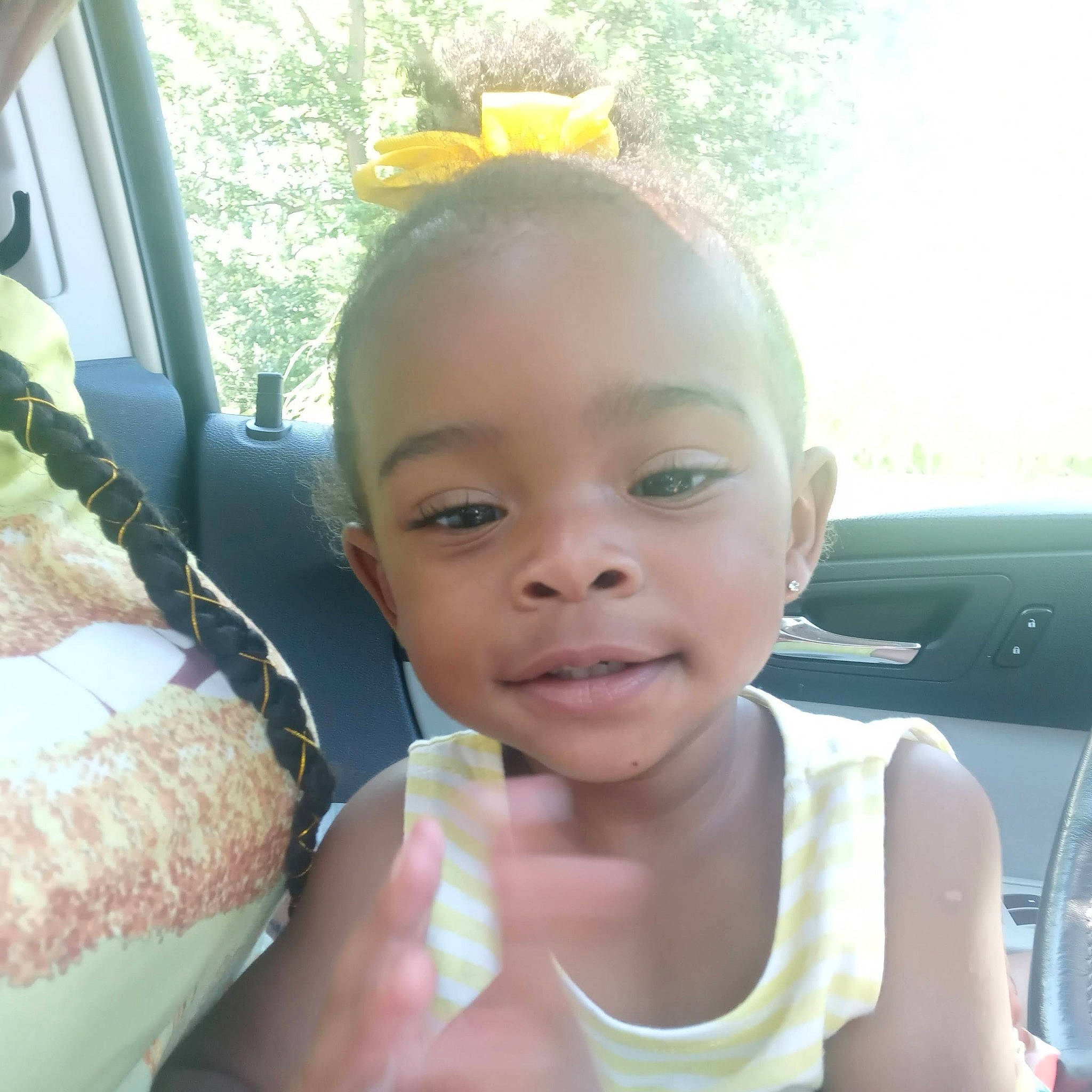 Reign Aylani is registered to the contest to win money with this photo: auto_part, baby_toddler_clothing, car_seat, child, ear, eyelash, face, family_car, finger, fruit, fun, gesture, grass, happy, joy, leisure, person, smile, summer, thumb