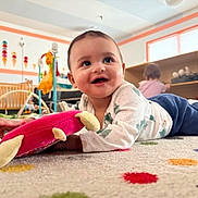Nevaeh is registered to the contest to win money with this photo: baby, child, toy, plush_toy, carpet, colorful, nursery, crib, furniture, smiling, indoor, playroom, person, crawling, happy, floor, clothing, sleepshirt, pants, toddler