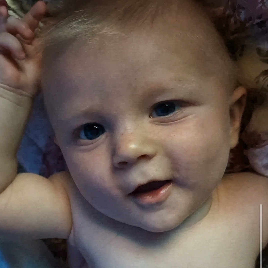 Bjorn is registered to the contest to win money with this photo: baby, infant, child, face, portrait, close_up, eyes, blue_eyes, open_mouth, curious, indoor, bed, bedding, hand, skin, head, shoulders, photograph, closeup_portrait, cozy