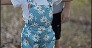 Charlee joined the competition — help win amazing prizes! child, girl, pigtails, romper, floral_pattern, outdoor, playful, person, nature, grass, smiling, shorts, white_shirt, standing, happy, casual_clothing, daylight, background_blur, fun, young