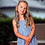 child, girl, blonde_hair, blue_dress, striped_dress, smile, outdoor, portrait, young, happy, posing, long_hair, headband, fashion, summer, cute, person, natural_light, casual, background_blur