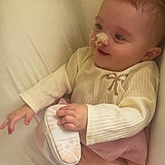 Wilyanna participe au concours pour gagner de l'argent avec cette photo : baby, child, infant, smile, face, hair, pigtails, nose_bandage, hand, footwear, shoe, clothing, pink, white, couch, furniture, indoor, portrait, cute, happy