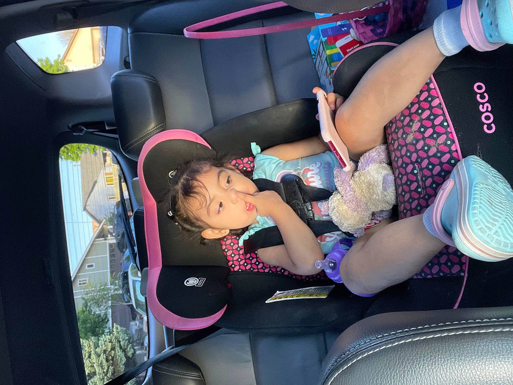 Selena is registered to the contest to win money with this photo: auto_part, automotive_design, automotive_exterior, car, car_seat, car_seat_cover, family_car, fun, head_restraint, human_leg, leg, mode_of_transport, motor_vehicle, person, seat_belt, steering_part, steering_wheel, thigh, toddler, vehicle