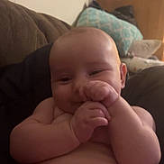 Nathan Beckett is registered to the contest to win money with this photo: baby, infant, diaper, couch, pillow, hands, smile, skin, chubby, sitting, indoor, cute, plump, face, head, arm, leg, relaxed, comfort, cozy