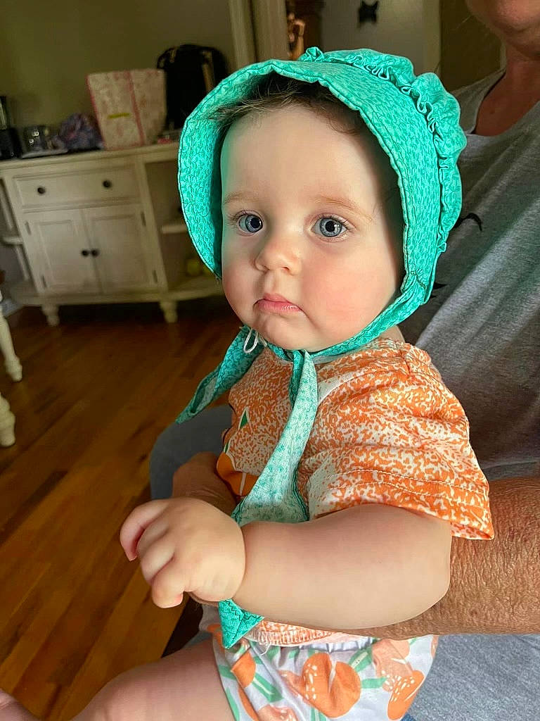 Zayda is registered to the contest to win money with this photo: baby, baby_toddler_clothing, cabinetry, cap, cheek, child, costume_hat, drawer, dress, event, eye, fun, happy, head, human_body, iris, person, skin, sleeve, toddler