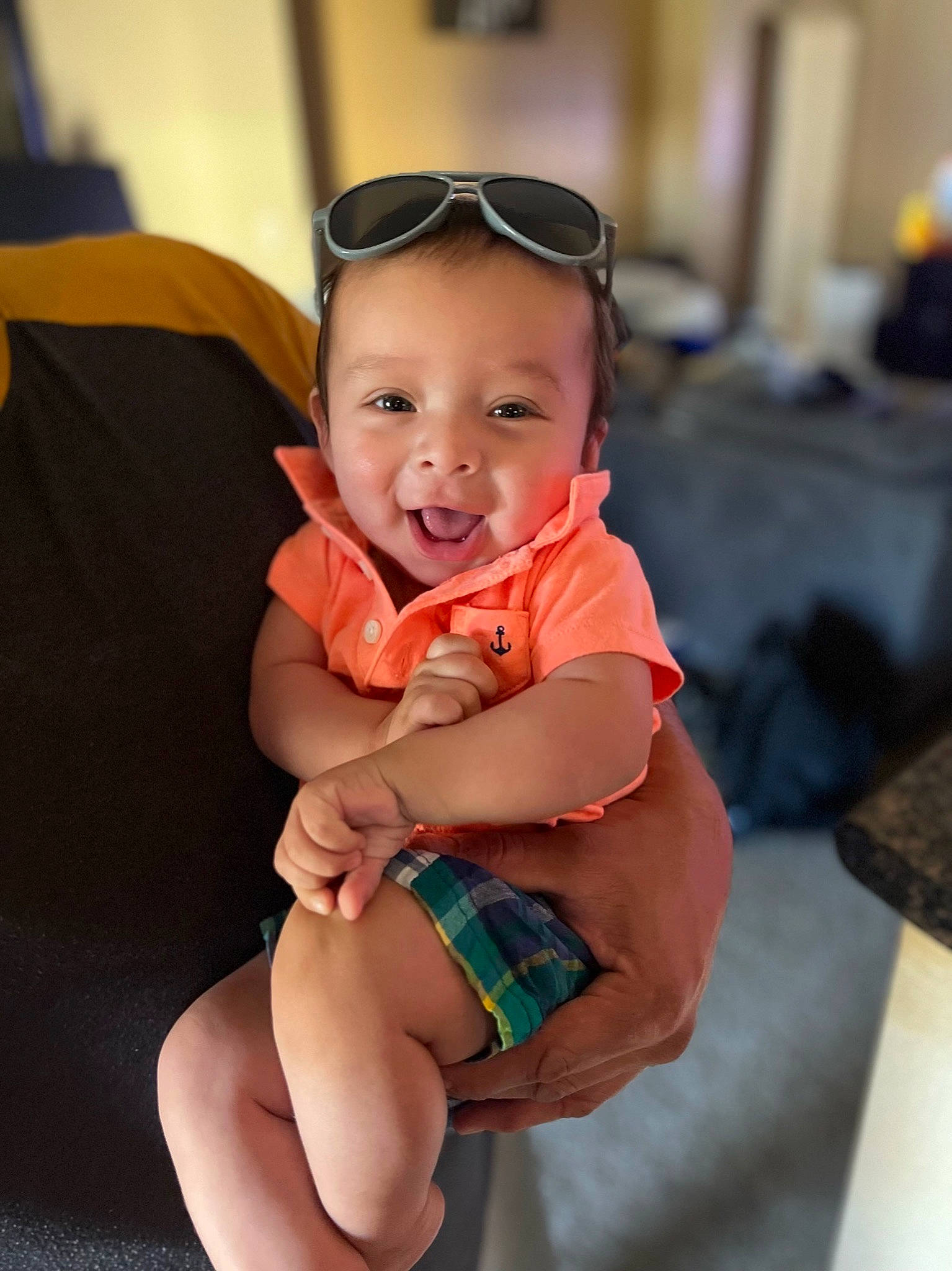 Luca is registered to the contest to win money with this photo: baby, baby_toddler_clothing, elbow, eyewear, finger, foot, goggles, happy, hat, head, human_leg, knee, leg, person, skin, smile, sunglasses, thigh, thumb, toddler