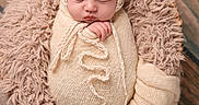 Astrid is registered to the contest to win money with this photo: newborn, baby, sleeping, knit_hat, basket, blanket, soft_texture, wood_floor, cozy, wrapped, pom_poms, infant, cute, portrait, indoor, peaceful, child, resting, warm, sleep