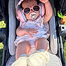 Astrid is registered to the contest to win money with this photo: baby, stroller, headphones, sunglasses, pacifier, infant, footwear, clothing, outdoor, sunlight, cute, child, baby_clothes, headwear, seat, comfort, relaxation, accessories, pink, floral