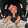 Astrid joined the competition — help win amazing prizes! baby, infant, car_seat, pink_bow, blanket, pacifier, smile, child, straps, black, seat, happy, cute, indoors, person, headwear, clothing, hands, face, portrait