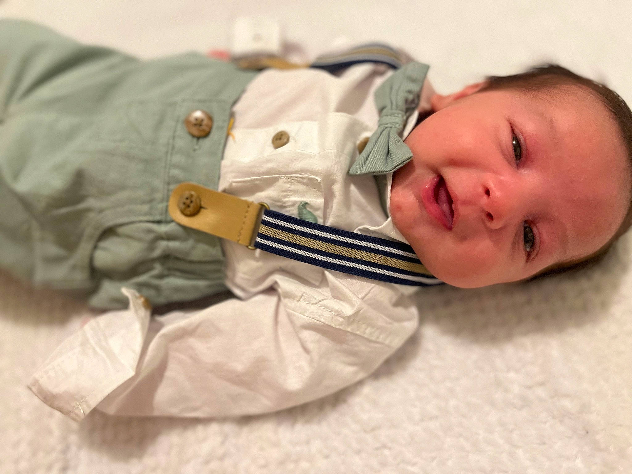 Iosua Jonathan is registered to the contest to win money with this photo: baby, baby_products, baby_toddler_clothing, child, comfort, eyelash, gesture, linens, musical_instrument, pattern, person, room, sleeve, smile, toddler