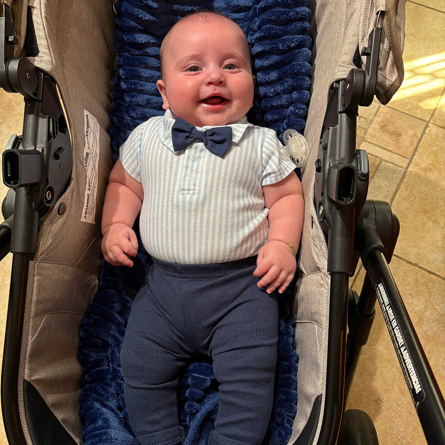 Damon Jiménez Romeu joined the competition — help win amazing prizes! baby, blanket, bow_tie, clothing, cushion, fabric, feet, footwear, hand, happy, head, indoor, infant, legs, person, portrait, skin, smile, stroller, toy