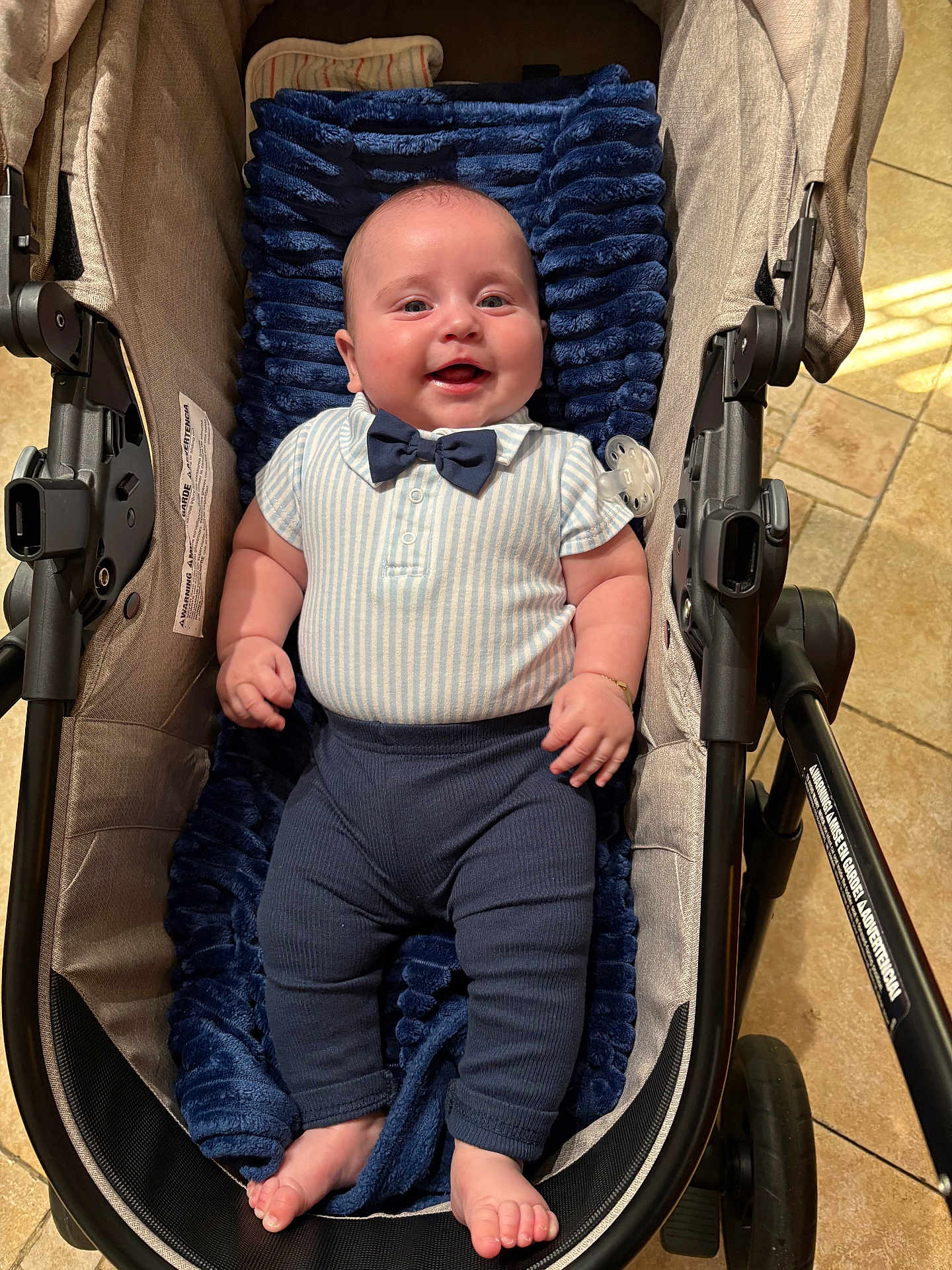 Damon Jiménez Romeu joined the competition — help win amazing prizes! baby, stroller, blanket, clothing, bow_tie, footwear, happy, infant, person, portrait, smile, indoor, fabric, cushion, legs, feet, hand, head, skin, toy