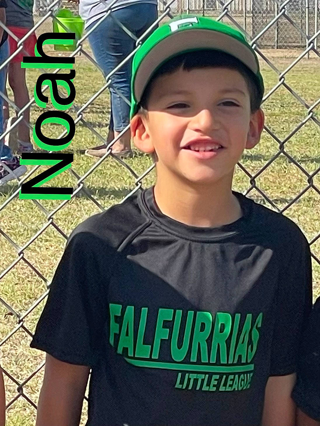 Noah is registered to the contest to win money with this photo: baseball_cap, cap, cool, eye, eyewear, face, facial_expression, fence, forehead, fun, grass, green, happy, hat, headgear, headwear, joy, neck, person, recreation