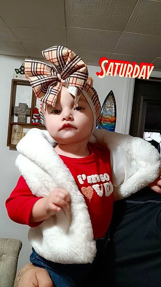 Adalyn is registered to the contest to win money with this photo: baby, baby_toddler_clothing, beanie, cap, child, costume, costume_hat, event, fashion_accessory, fictional_character, fur, headgear, headpiece, headwear, human_body, insect, knit_cap, person, santa_claus, sleeve