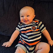 Oden is registered to the contest to win money with this photo: baby, baby_boy, baby_girl, child, couch, cute, expression, face, hand, happy, head, indoor, infant, legs, onesie, portrait, sitting, skin, smiling, striped_clothing