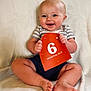 Oden joined the competition — help win amazing prizes! baby, smiling, infant, child, striped_shirt, shorts, sitting, blanket, sign, age_marker, happy, cute, portrait, indoors, skin, feet, hands, head, face, blue_eyes