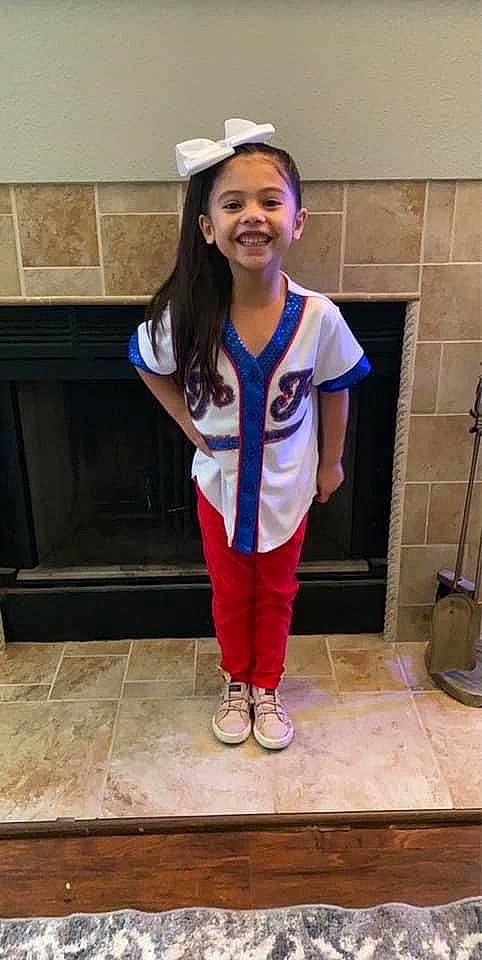 Audrie is registered to the contest to win money with this photo: child, child_model, clothing, electric_blue, joy, person, sleeve, t_shirt, uniform