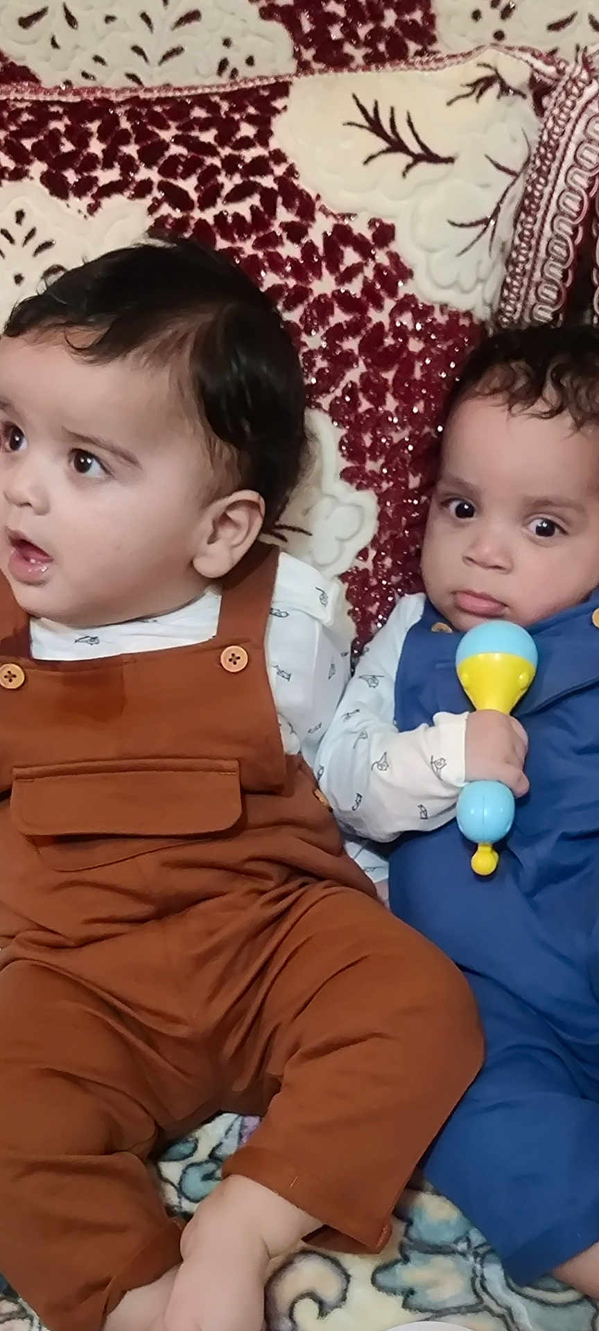 Ibrahim Et Salman participe au concours pour gagner de l'argent avec cette photo : babies, baby, blanket, child, closeup, clothing, curly_hair, cushion, cute, expression, face, indoor, infant, overalls, patterned, person, rattle, sitting, toy, young_child