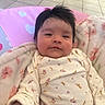 Valentina is registered to the contest to win money with this photo: baby, blanket, child, cozy, cute, face, floral_pattern, hair, indoor, infant, long_sleeves, lying_down, pink, portrait, relaxed, skin, soft_texture, tiled_floor, warm, white_clothing
