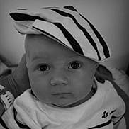 Paul a rejoint le concours — aidez-le/la à gagner de superbes lots ! baby, baby_clothes, black_and_white, child, closeup, clothing, cute, expression, eyes, face, fashion, hand, hat, headwear, infant, looking, person, portrait, striped_hat, young