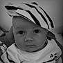 baby, baby_clothes, black_and_white, child, closeup, clothing, cute, expression, eyes, face, fashion, hand, hat, headwear, infant, looking, person, portrait, striped_hat, young