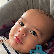 Aylan participe au concours pour gagner de l'argent avec cette photo : baby, infant, child, pacifier, portrait, close_up, eyes, smile, cheeks, head, skin, onesie, striped_clothing, blanket, car_seat, indoor, cozy, gaze, adorable, baby_accessory