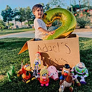 Jose Adael joined the competition — help win amazing prizes! balloon, buzz_lightyear, cardboard_box, child, daylight, grass, horse, mr_potato_head, mrs_potato_head, number_2, outdoor, park, piggy_bank, rex, slinky_dog, smiling, toddler, toy_story, toys, woody