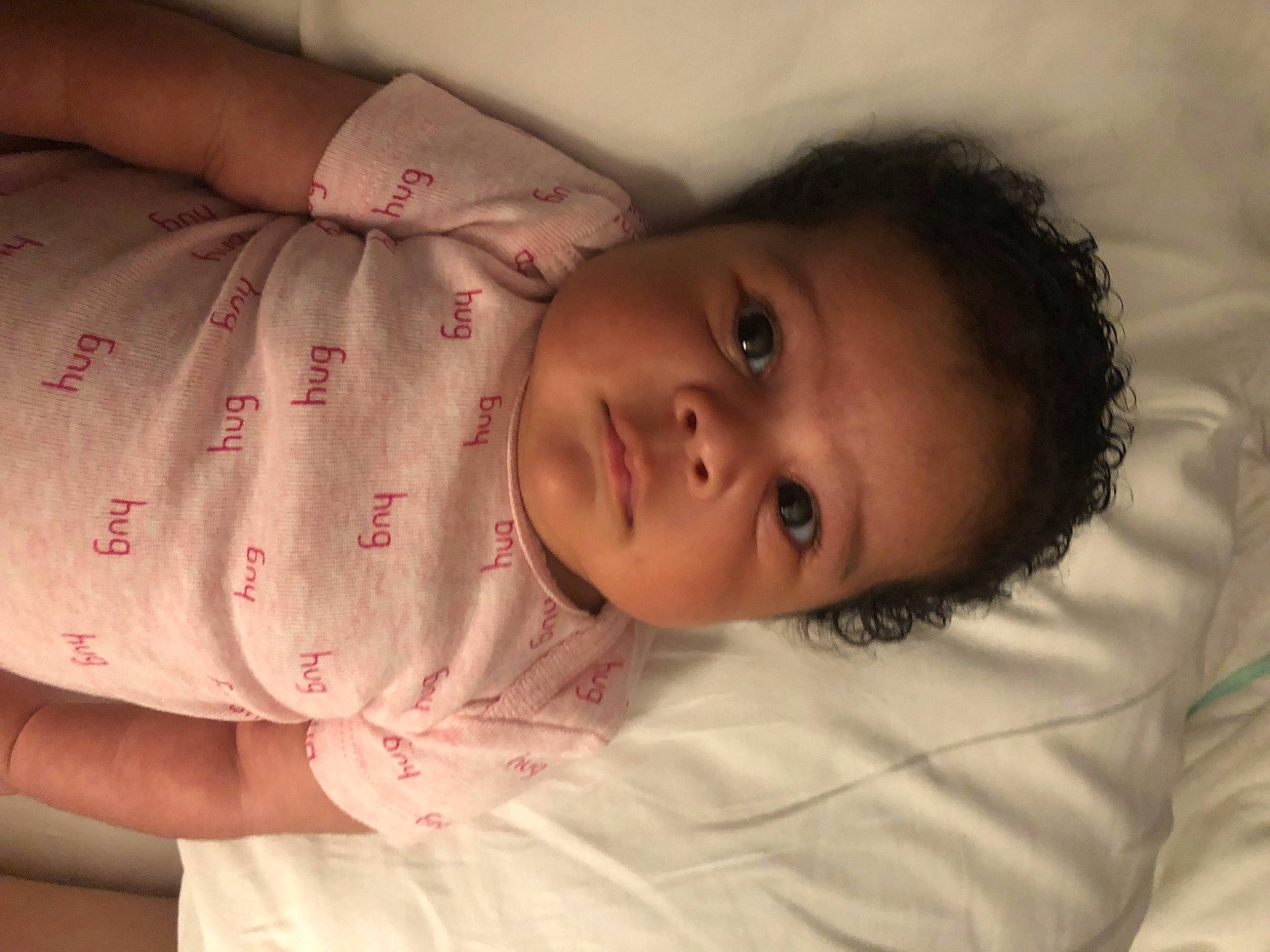 Londyn is registered to the contest to win money with this photo: arm, baby, bedtime, cheek, child, chin, eye, eyebrow, face, forehead, hand, head, iris, lip, mouth, nose, person, pink, skin, smile