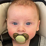 Malikai joined the competition — help win amazing prizes! baby, blue_eyes, car_seat, child, close-up, clothing, curious, expression, face, hand, head, indoor, infant, pacifier, person, portrait, seatbelt, skin, straps, young_child